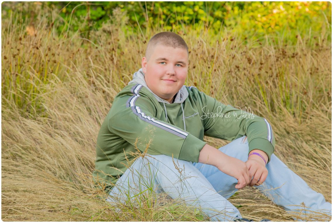 lake stevens high school sitting in tall grass senior portraits