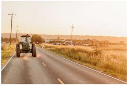 This beautiful photo captures the essence of “Tractoring Love” perfectly — a romantic and rustic scene featuring a tractor driving into the golden sunset, likely after Allie and Alex’s wedding celebration at Snohomish Stocker Farms. The soft amber lighting, wide country road, and heart shapes on the rear window of the tractor create a dreamy, heartfelt moment that blends country charm with love’s quiet joy. If you'd like, I can help turn this image into a keepsake design, like a wedding thank-you card or personalized print.