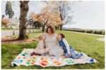 Families posing under blooming cherry blossom trees at Grand Avenue Park in Everett, WA during spring mini photo sessions.