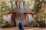 Couple standing together in front of a rustic wooden barn at McMenamins Cornelius Pass Roadhouse in Hillsboro, Oregon, surrounded by trees and warm October sunlight.