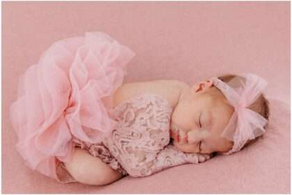 A little girl named Brooklyn in a downtown Everett studio wearing pink princess dresses with tulle and lace, posing in a soft, dreamy studio setting filled with feminine, girly decor.