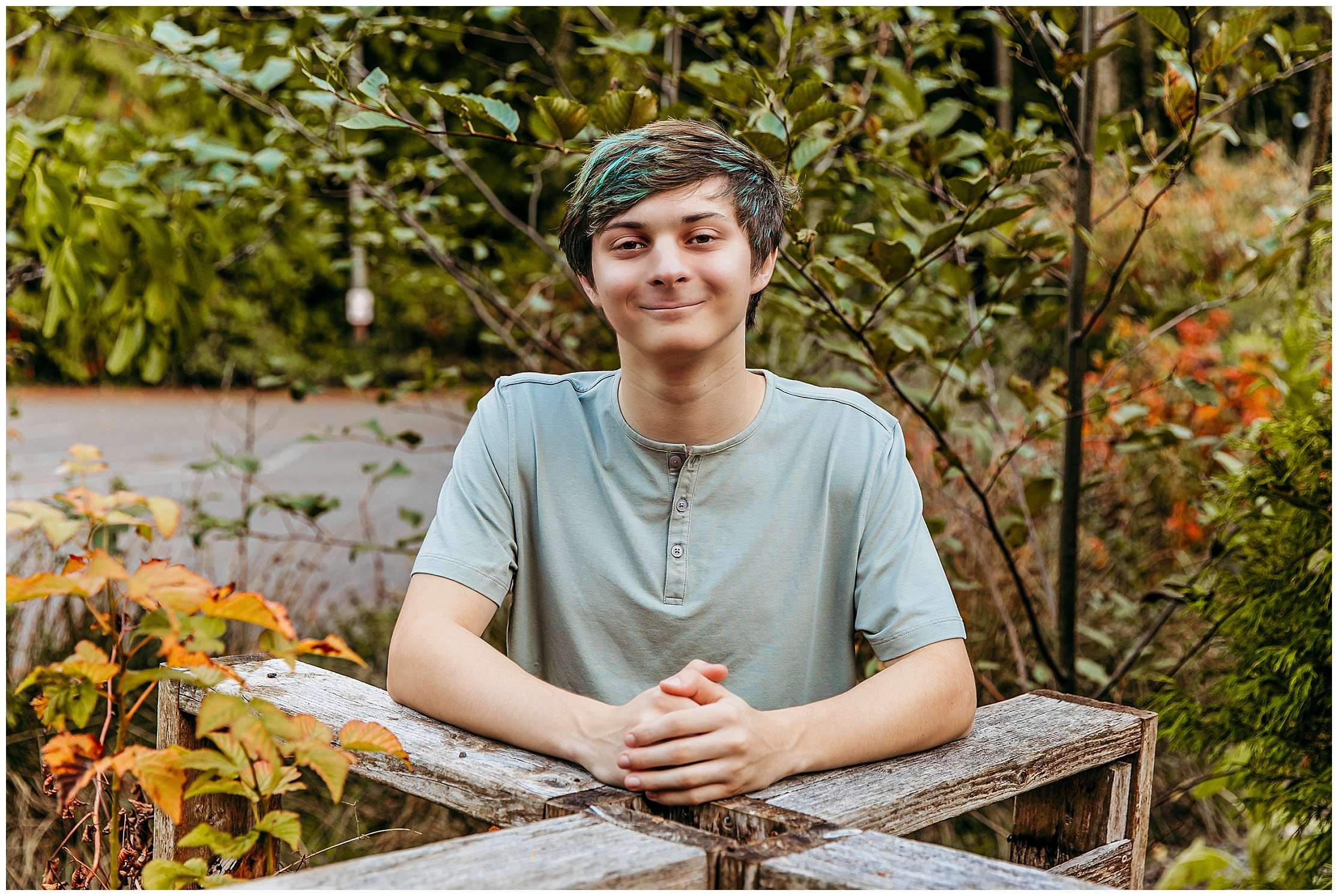 High school senior boy posing outdoors at McCollum Park with natural greenery background during simple casual senior photo session
