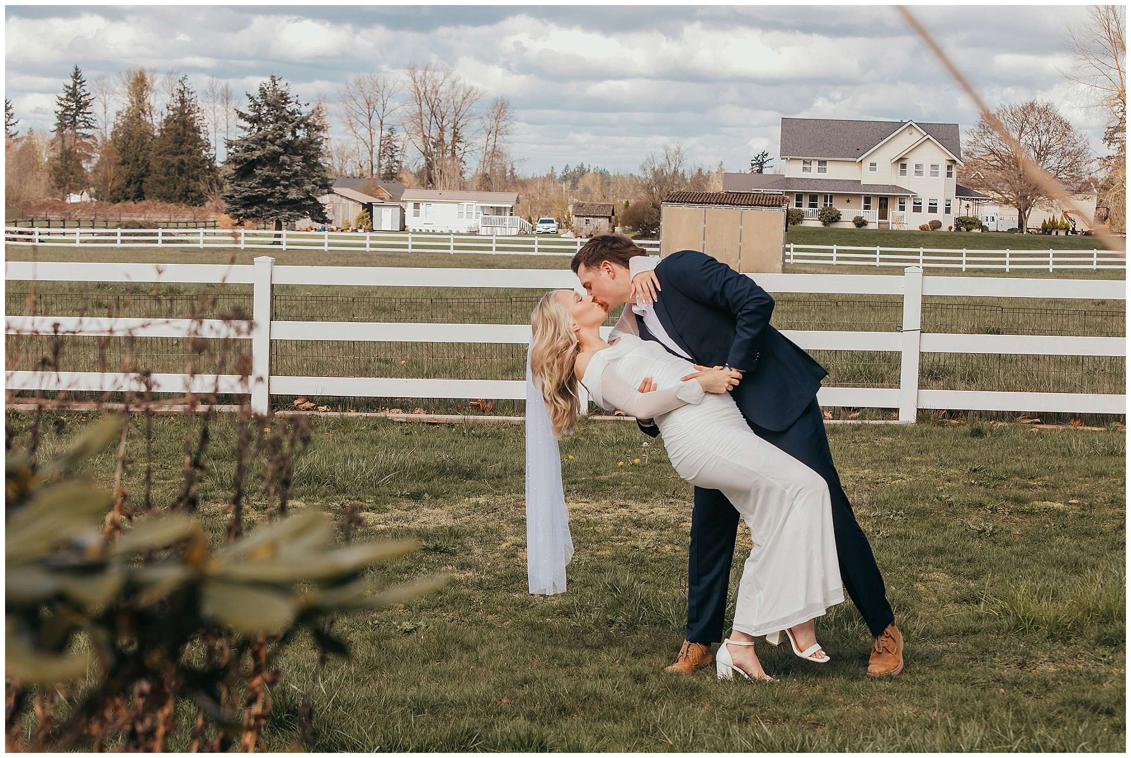 Bride and groom sharing a romantic dip kiss during their small outdoor elopement in Enumclaw while celebrating their pregnancy gender announcement.